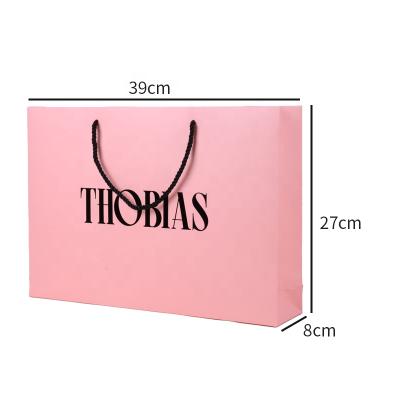 China Recycled Paper Eco-friendly Materials Pink Cardboard Elegant Packaging Bags With Cotton Handle for sale