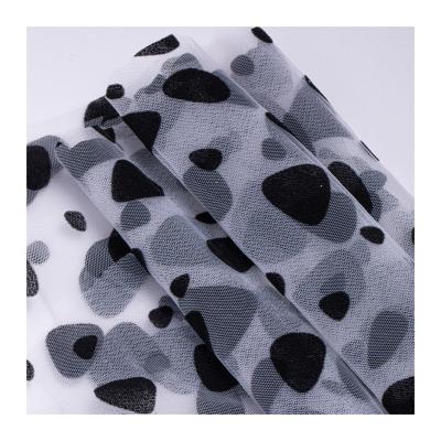 China Breathable Fashionable Design Panda Eyes Black Dot Flocked Flocked Printing Fabric for Dressing and Sewing Decoration for sale