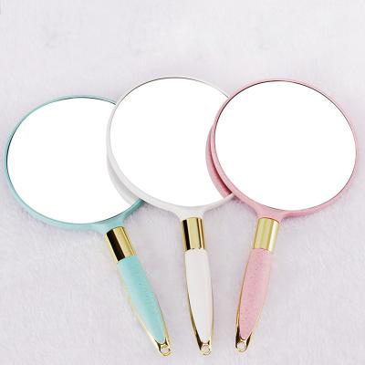 China Round Mini Portable Cosmetic Tool Single Side Magnifying Makeup Handheld Mirror With Handle for sale