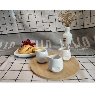 China Mini Sustainable White Ceramic Cream Bottle Without Handle Sauce Cup Porcelain Milk Cup for sale