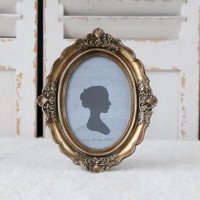 China Resin Relief Oval Resin Picture Frame European Style Cutout View Retro Old Can Be Wall Hung Copper Color Picture Frame Wholesale for sale