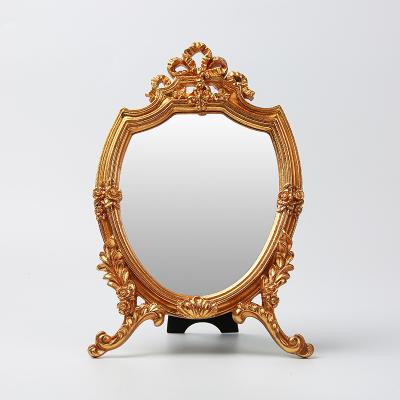 China Resin Vintage Gold Vintage Bow Cosmetic Mirror Dresser Mirror Decoration Minimalist Wall Hanging Mirror for sale