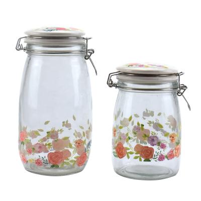 China 950ml 1400ml Viable Round Decal Glass Candy Jar Storage Jar Cookie Jar With Clip Lid for sale