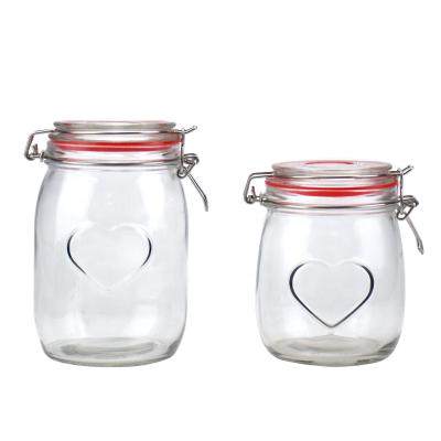 China 950ml 650ml Round Heart Viable Transparent Glass Storage Jar Glass Candy Jar With Glass Clip Lid for sale