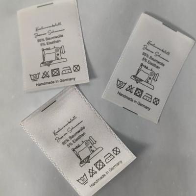 China With Your Contents 500pcs Fabric Labels, 3*4.5cm Satin Ribbon Custom White Printing Wash Label Clothing Care Label for sale