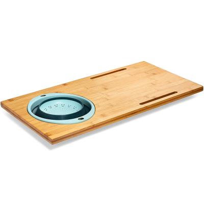 China Viable Bamboo Sink Cutting Board With Collapsible Removable Strainer And Phone Slots for sale