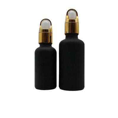 China Dropper Sale Matte Frosted Black Glass Dropper Essential Oil Bottles With Flower Basket Lid for sale