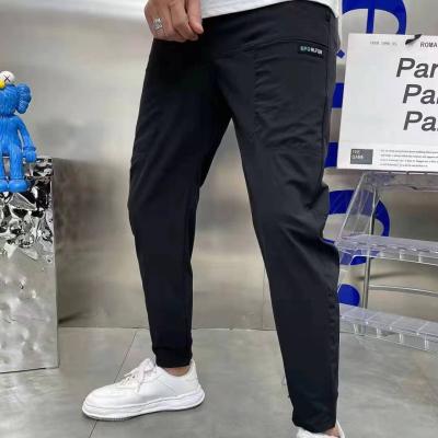 China Flat Front Style Mens Cargo Pants InStock with Custom Buttons Loose Fitness Joggers for sale