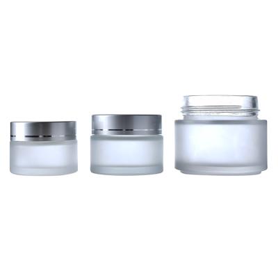 China 100g Personal Care Glass Jar 5g 10g 15g 20g 30g 50 Clear Frosted Glass Jar With Silver Lid For Cosmetic Packaging for sale