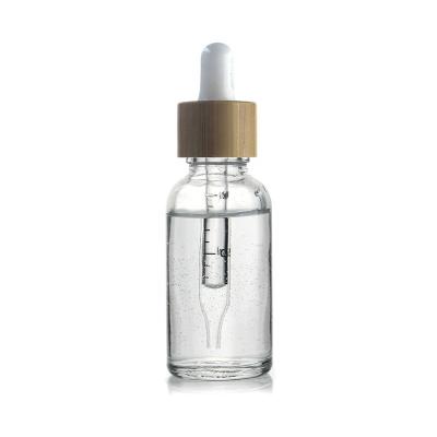 China Cosmetic Glass Bottle With Lid Dropper Glass Bottle Bamboo Serum Bottle 30ml for sale