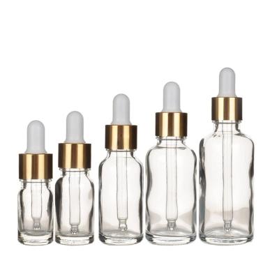 China Clear Cosmetic Glass Dropper Bottle With Gold Dropper 5ml 10ml 15ml 20ml 30ml 50ml 100ml for sale