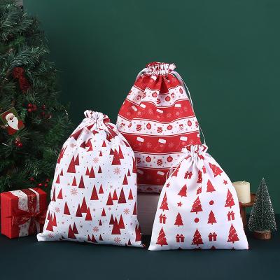 China Carta patrón Tipo bolsas de cuerda grande bolsas de algodón de Navidad Santa bolsas de regalo en venta