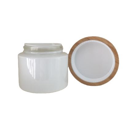 China 100g 150g 200g large volume cosmetic cream glass clear frosted cream jar with bamboo lid for cream packaging for sale