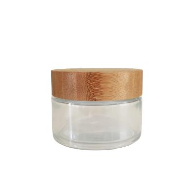 China Wholesale Cosmetic In Stock 100g Clear / Frosted Glass Jar With Bamboo Wooden Lid For Cream for sale