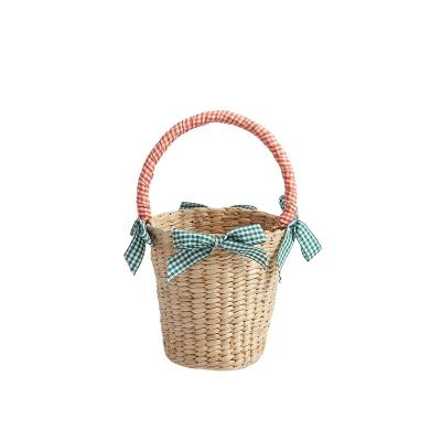 China 2021 Cute Summer Design RADISH Straw Woven Bag Mini Bucket Ribbon Bohemian Grid Bowknot Kids Picnic Knitting Handbag for sale