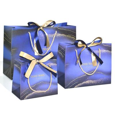 China Clothing Carry Reusable Shopping Packaging Luxury Custom Logo Printed Luxury Paper Gift Bags Clothing Shopping Packaging Paper Bags With Ribbon Handle for sale