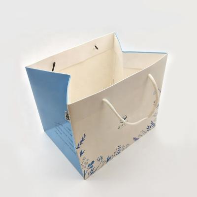 China Recycled Materials Wholesale Custom Printed Recyclable White Luxury Shopping Paper Gift Bag With Handle for sale