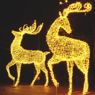 China Commercial Use Customized Outdoor Yard Decoration Lighted Animal Sculpture Holding 3d Pattern Lights Reindeer For Holiday Christmas Celebration for sale