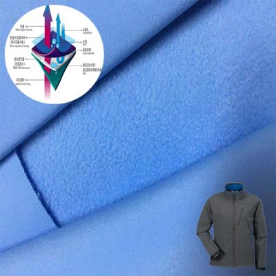 China Waterproof 4 way mechanical stretch bonded waterproof breathable fleece tpu film 3 layer softshell fabric for outdoor ski wear fabric for sale