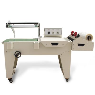 China Semi Automatic Pneumatic PVC/PP/POF/PE Products Film Shrink Wrapping Packing Machine Price for sale