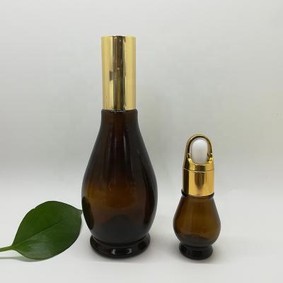 China Personal care 10ml 20ml 30ml 50ml 100ml simple essential oil gourd shape dark brown glass bottle with gold dropper for sale