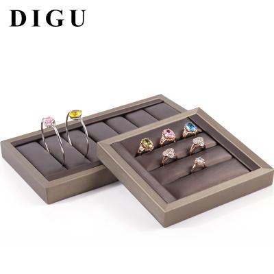 China OEM+ODM+Wholesale DIGU Custom PU Leather Jewelry Bangle Swept Display Props Wedding Ring Tray Jewelry Display Stand Storage Shelf for sale