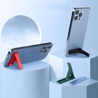 China Notebook Bracket Mini Portable Kickstand Alloy Invisible Adjustable Non-slip Mobile Phone Stand Holder For Smartphones for sale