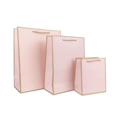 China Recyclable Custom Luxury Clothes Store Retail Pink Packaging Gift Carry Bags Shopping Paper Bags With Your Own Logo for sale