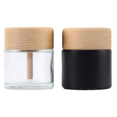 China 50ml Round Shape Cosmetic Wholesale Custom Clear Empty Glass Diffuser Bottle With Wooden Cap for sale