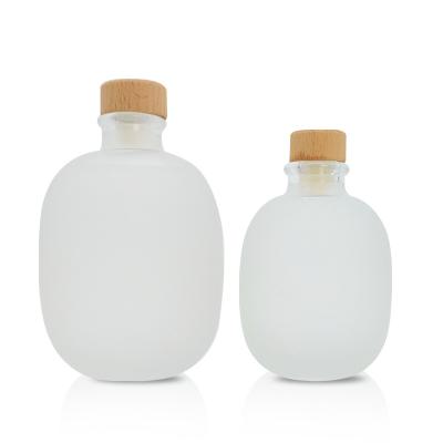 China Environmental Friendly Popular 100ml 250ml 500ml Frosted Round Wine Bottle Glass Vodka Bottle With Cork for sale