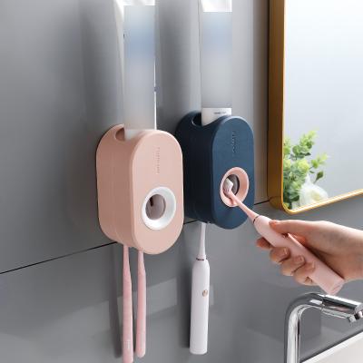 China Viable Automatic Toothpaste Squeezer Toothbrush Holder Wall Mounted Suction Toothpaste Squeezer for sale