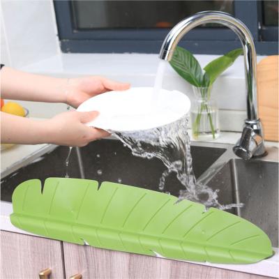 China Viable Creativity Kitchen Water Divider Faucet Wash Basin Sucker Silicone Sink Splash Guard for sale