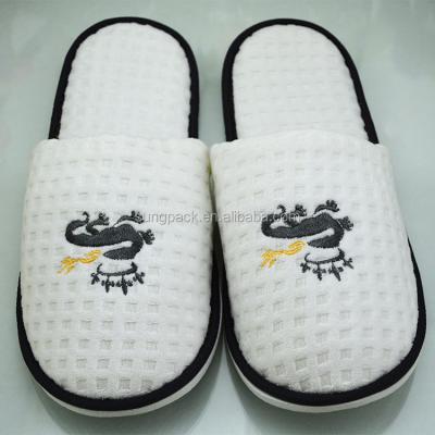 China Disposable Slippers Terry Cloth White Hotel Slippers Disposable with Logo EVA Rubber Sole Waffle Slippers Customized for sale