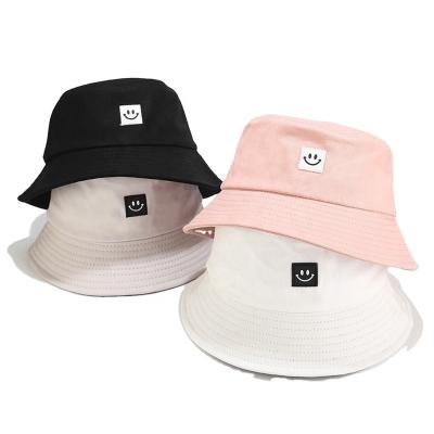 China Top Selling Guaranteed Quality Striped Personalized Custom Embroidery Smiley Face Trendy Street Bucket Pink Black Hat For Men for sale