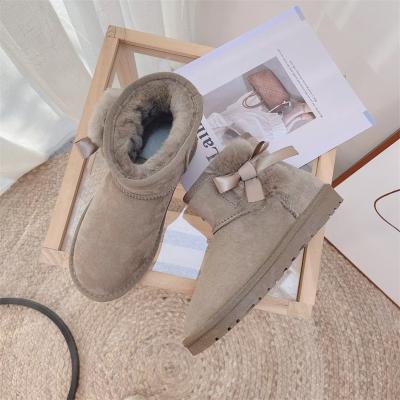 China Non-slip Breathable Lady Sheep Fur One Body Short Tube Snow Uggging Cotton Flat Thick Warm Shoes Bow Short Boots Leather for sale