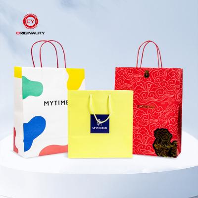 China Recyclable custom printed luxury large boutique shopping bag customized paper bag with your own logo for sale