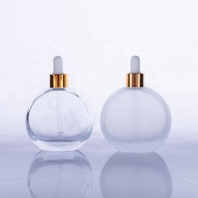 China Personal Care 50ml Essential Oil Bottles Glass Dropper Empty Flat Round Essential Oil Bottle for sale