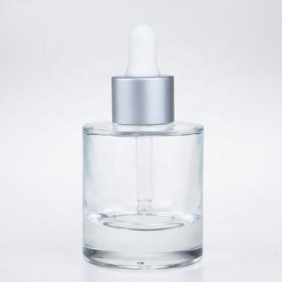 China Cosmetic Round 30ml Shoulder Bottom Serum Thick Flat Clear Empty Essential Oil Dropper Glass Bottle for sale