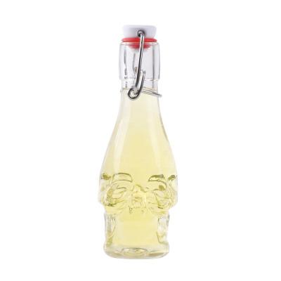 China Drinking Beverage 150ml Double Tiki Face Juice Oil Swing Lid Bottles for sale