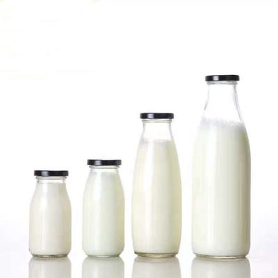 China Personal Care 250ml 500ml 1000ml Clear Milk Glass Bottle With Metal Cap for sale