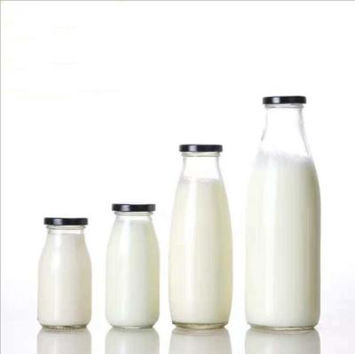 China Transparent Personal Care Round 500ml Milk Tea Glass Bottle Carrier for sale