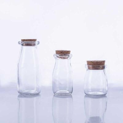 China 200ml Food Empty Transparent Glass Milk Bottles With Wooden Lid for sale