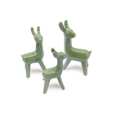 China Handwork Customized Color Green Ceramic Reindeer Figurine For Christmas Home Decoration for sale