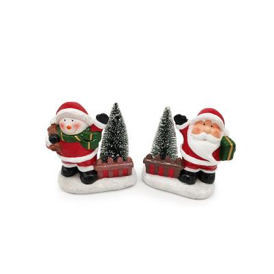 China Handmade Ceramic Home Ornament Snowman Santa Claus Figurine With Plastic Christmas Tree for sale