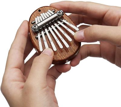 China Good Gift Kalimba Accessory GIF 8 Mini Round Musical Exquisite Marimba Thumb Finger Piano Pendant Kalimba 2.76 x 1.97 x 0.67 inch for sale