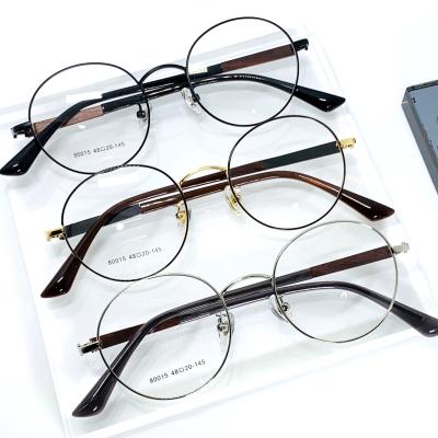 China Hot-selling optical frame fashion men and women metal round eyeglasses frame leaf foot feature design light wood frame for sale