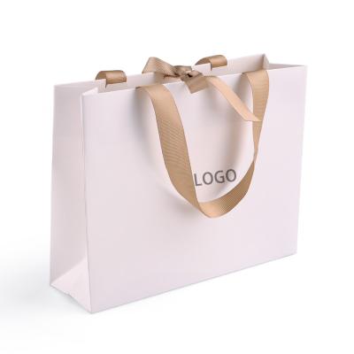 China Recyclable Luxury Shopping Bags Custom Logo Printed Boutique Shopping Bags With Ribbon for sale