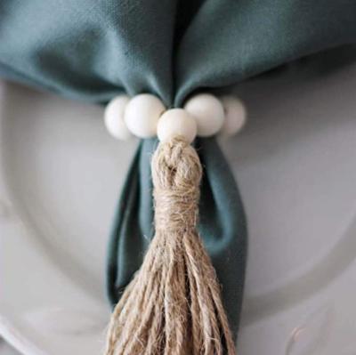 China Sustainable Pastoral Natural Wood Beaded Napkin Ring For Party Home Wedding Reception Dining Table Arrangement With Linen Tassel for sale