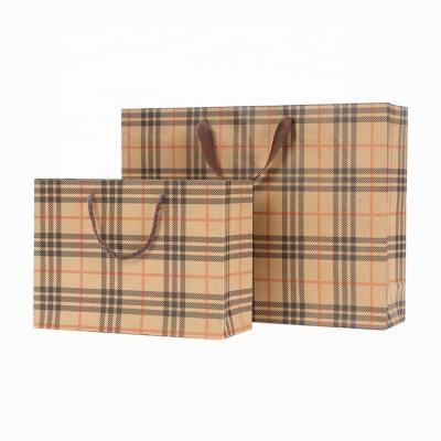 China Custom Printing Biodegradable Logo Kraft Paper Bag Gift Apparel Packaging Shopping Bag Lattice Portable Paper Bag for sale