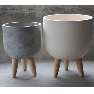 China Home and Garden CLASSIC Fiberglass Cement Small Round Flower Pots Cement Planter Pot with Wooden Feet for sale